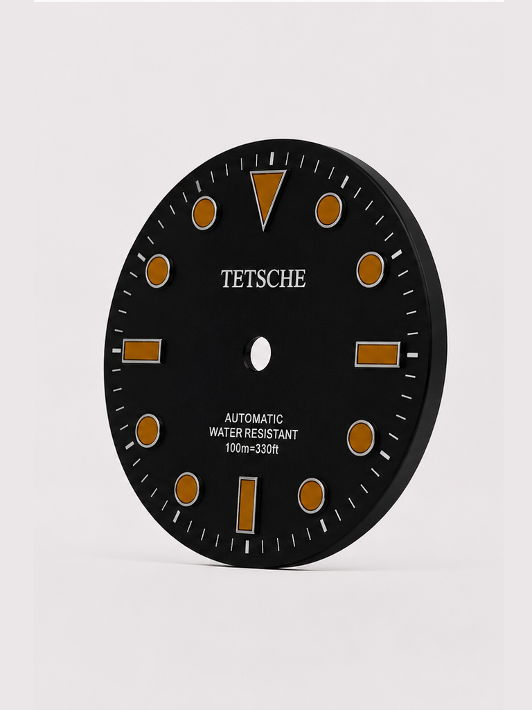 A classic black with orange index dive-inspired dial with a clean, balanced design. The applied hour markers and bold 12 o’clock index provide excellent visual structure, while the subtle sunburst finish adds depth as the light moves across the dial.

Designed to work beautifully in both sporty and more understated builds.

Details

28.5 mm diameter
Applied hour markers
Date window at 3 o’clock
Sunburst finish
Designed for automatic watch builds