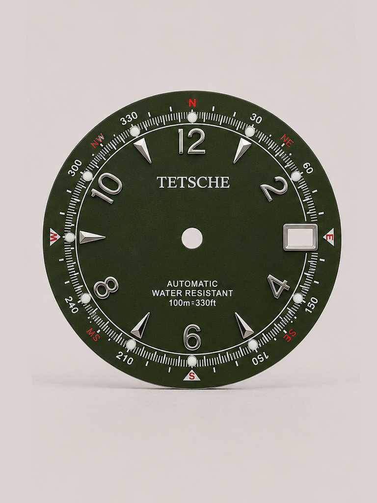 An adventure-inspired dial with a bold, instrument-style design. The combination of applied numerals, directional markings and a detailed outer scale gives the dial the character of a classic navigation instrument, while the contrasting red accents add a distinctive touch.

A perfect choice for a rugged, explorer-inspired watch build with plenty of personality.

Green
* 28.5 mm diameter
* Applied Arabic numeral hour markers
* Detailed compass-inspired outer scale
* Date window at 3 o’clock
* Contrast