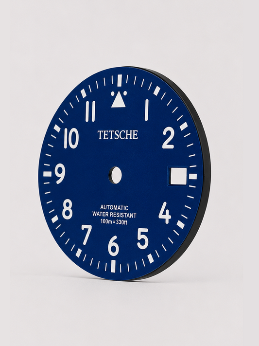 A clean field-inspired dial designed around maximum legibility and simplicity. The bold Arabic numerals, high-contrast minute track and distinctive 12 o’clock marker give the dial a functional, utilitarian character reminiscent of classic expedition and field watches.

A great choice for a rugged everyday build with a clean, understated look.

Blue
* 28.5 mm diameter
* Arabic numeral hour markers
* High-contrast minute track
* Date window at 3 o’clock
* Distinctive 12 o’clock marker
* Designed for a