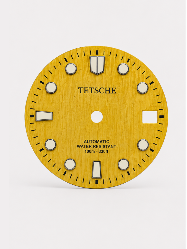 A bold vintage-inspired dial with a distinctive woodgrain-style texture that gives the surface a rich sense of depth and character. The applied hour markers provide a clean contrast against the deep green finish, combining classic dive-watch elements with a more unconventional retro look.

A great choice for a watch build with a natural, distinctive personality.

Yellow
28.5 mm diameter
Applied hour markers
Woodgrain-style textured finish
Detailed outer minute track
Date window at 3 o’clock
Designed for a