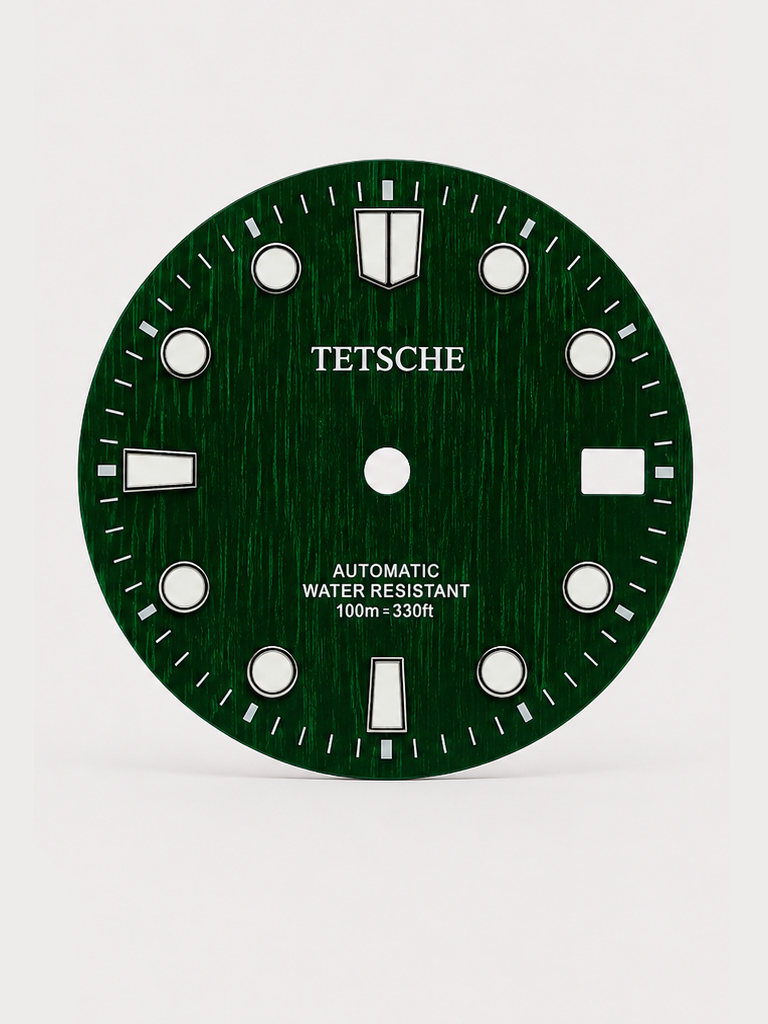 A bold vintage-inspired dial with a distinctive woodgrain-style texture that gives the surface a rich sense of depth and character. The applied hour markers provide a clean contrast against the deep green finish, combining classic dive-watch elements with a more unconventional retro look.

A great choice for a watch build with a natural, distinctive personality.

Green
28.5 mm diameter
Applied hour markers
Woodgrain-style textured finish
Detailed outer minute track
Date window at 3 o’clock
Designed for a