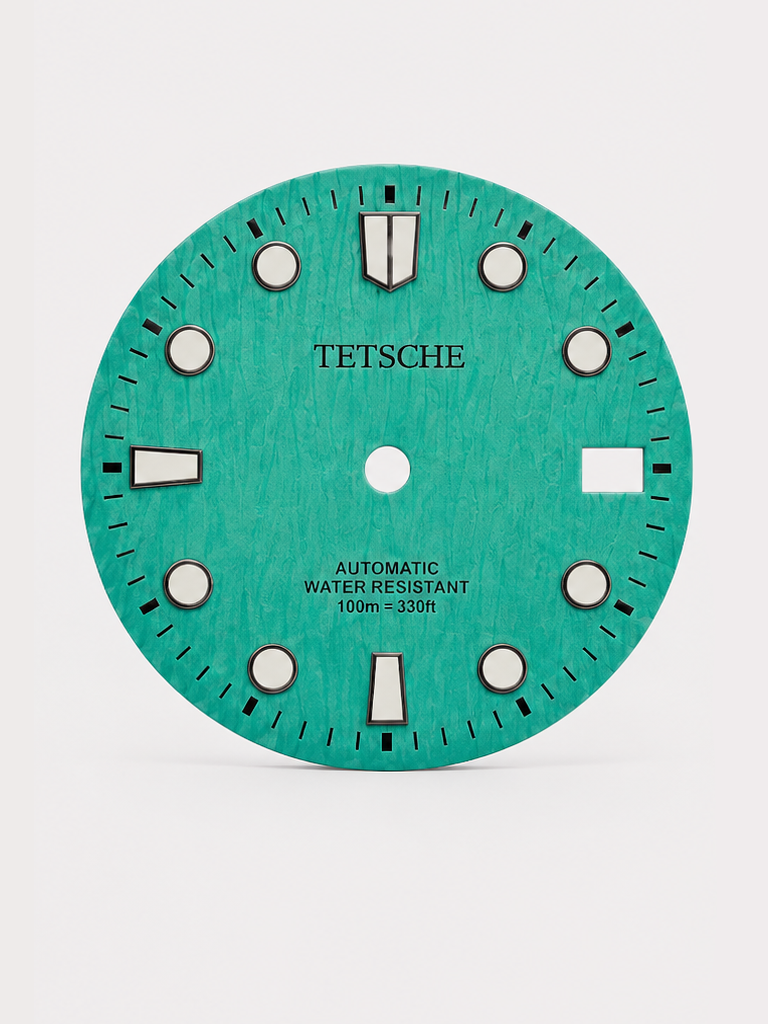 A bold vintage-inspired dial with a distinctive woodgrain-style texture that gives the surface a rich sense of depth and character. The applied hour markers provide a clean contrast against the deep green finish, combining classic dive-watch elements with a more unconventional retro look.

A great choice for a watch build with a natural, distinctive personality.

MintBlue
28.5 mm diameter
Applied hour markers
Woodgrain-style textured finish
Detailed outer minute track
Date window at 3 o’clock
Designed for a