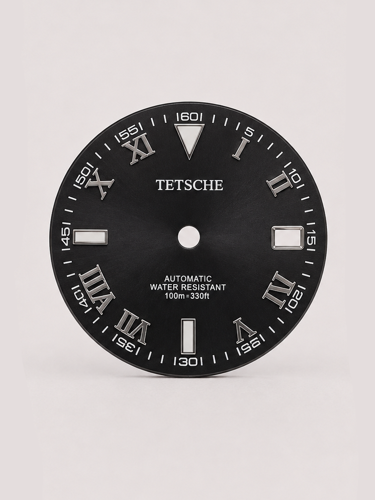 A distinctive dial that combines classical Roman numerals with a more technical, contemporary layout. The outer minute markings add depth and character, while the applied silver-tone details stand out against the dark dial for a bold yet refined appearance.

A great choice for a classic watch build that blends traditional design with a modern edge.

Black
28.5 mm diameter
Applied Roman numeral hour markers
Detailed outer minute track
Date window at 3 o’clock
Silver-tone details
Designed for automatic wat